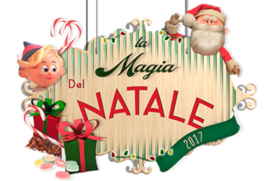 Cartello decorativo con la scritta 'La Magia del Natale' e immagini di Babbo Natale e un elfo, con regali e dolci.